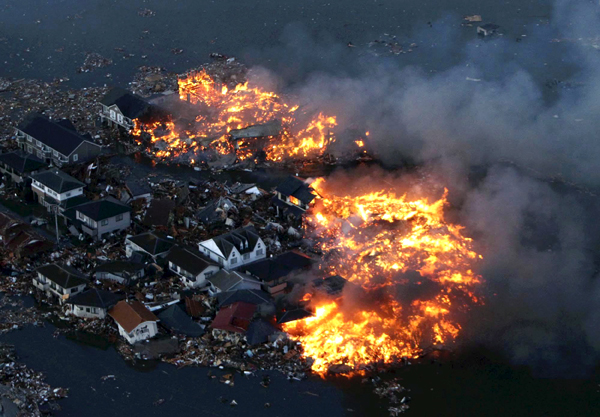 Japanese homes in flames after tsunami