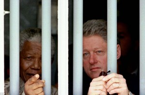 Nelson Mandela and Bill Clinton looking our from Mandela's old cell on Robbin Island