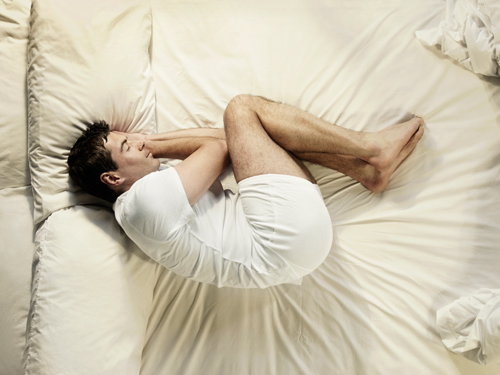 Image of a man in a foetal position